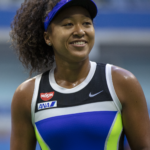 Naomi Osaka smiling during a tennis match, showcasing her confidence and sportsmanship