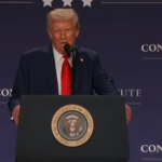 Donald Trump delivering a speech at a press conference.