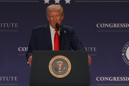 Donald Trump delivering a speech at a press conference.