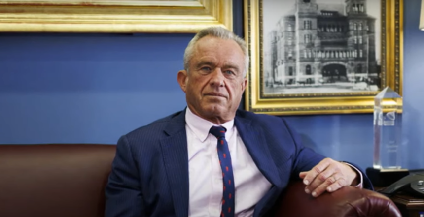 Robert F. Kennedy Jr. sitting in an interview setting, discussing political matters.