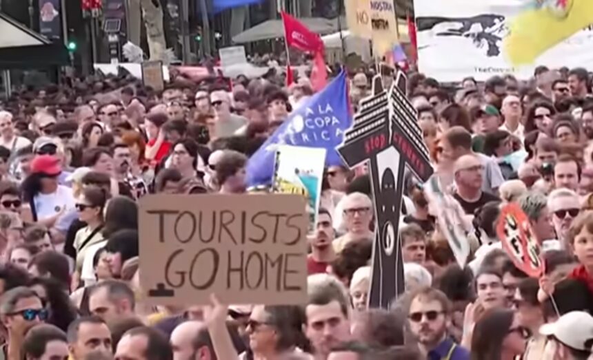 Protesters with signs advocating for tourism control in Spain, addressing housing and local community concerns