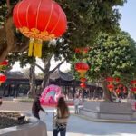 A colorful street celebration with red lanterns and decorations marking the Chinese New Year festivities