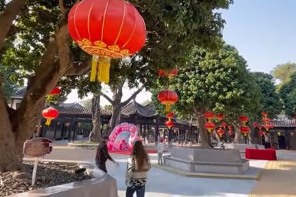 A colorful street celebration with red lanterns and decorations marking the Chinese New Year festivities