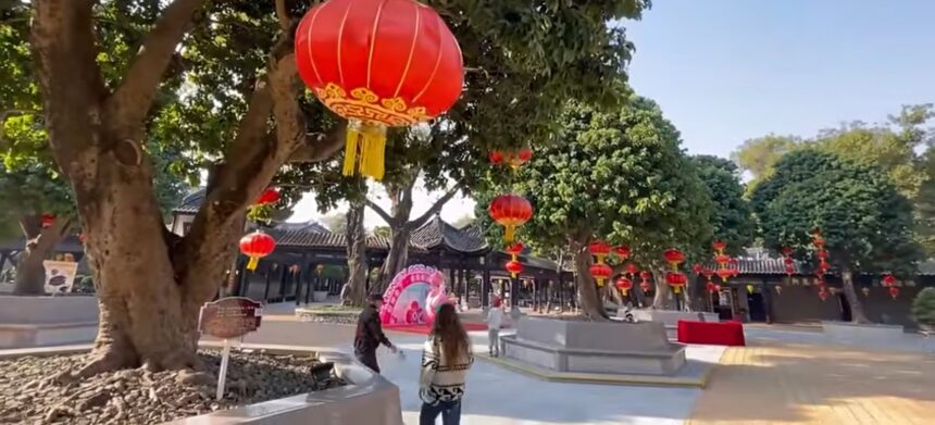 A colorful street celebration with red lanterns and decorations marking the Chinese New Year festivities