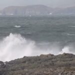 Rough seas with large waves crashing against the rocks, highlighting the impact of Storm Herminia in coastal areas of the UK