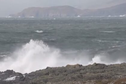 Rough seas with large waves crashing against the rocks, highlighting the impact of Storm Herminia in coastal areas of the UK