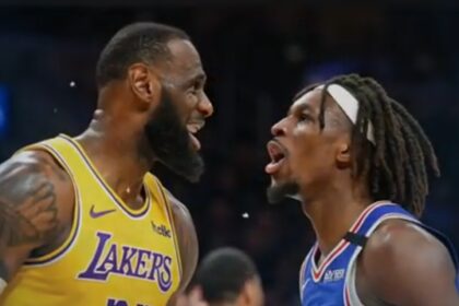 A live-action basketball game between the Los Angeles Lakers and the Philadelphia 76ers, capturing an intense moment on the court with players in motion