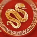 Lunar New Year 2025 Snake Symbol - A golden snake on a red background representing the Year of the Snake in Chinese astrology