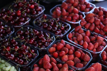 Fresh strawberries in baskets displayed at a market