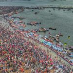 A breathtaking aerial view of the Maha Kumbh Mela at Triveni Sangam, showing millions of devotees gathered for the sacred ritual bath.