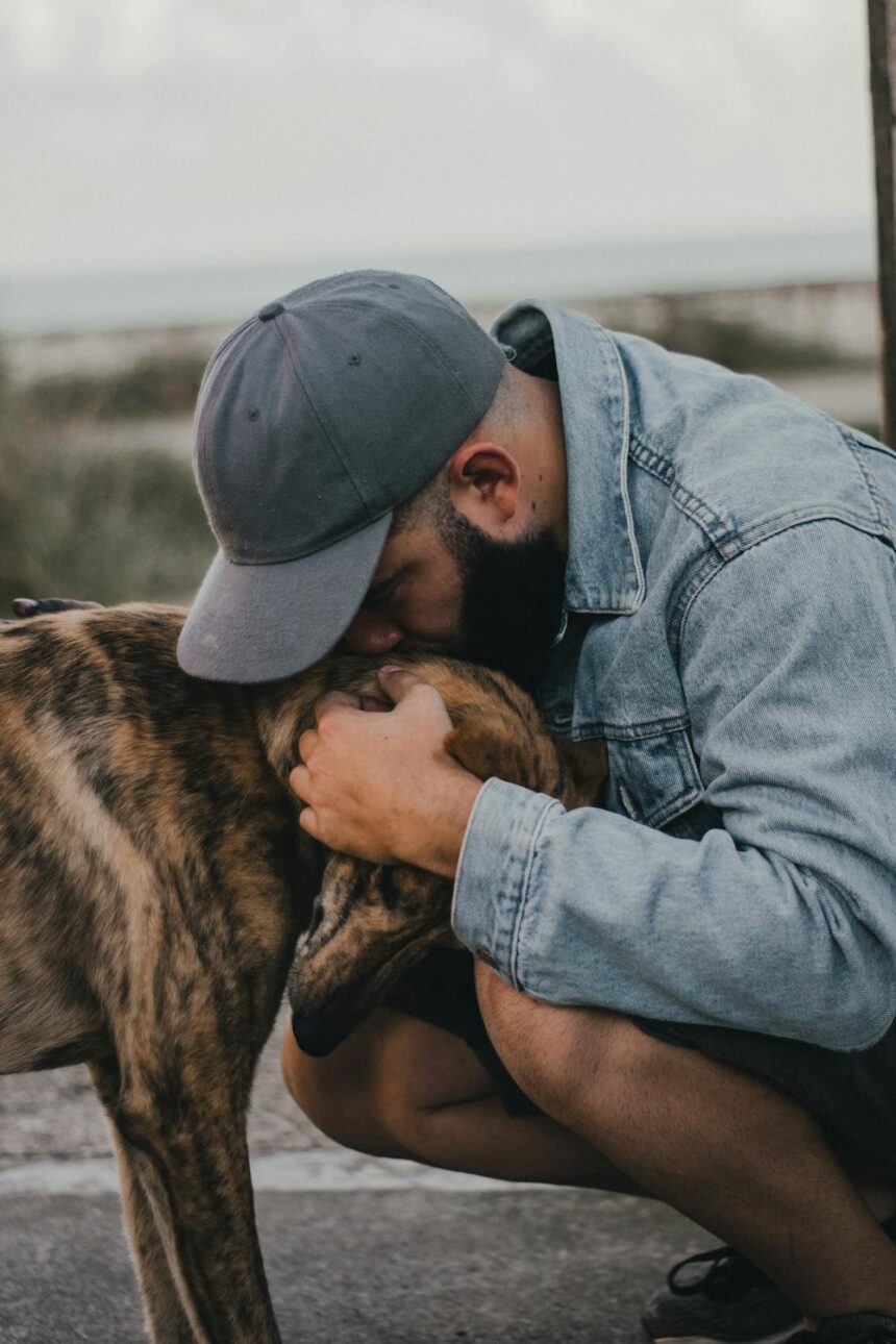 A man emotionally hugging his dog during a heartwarming reunion, symbolizing the strong bond between humans and their pets