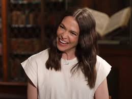 Sutton Foster smiling in a casual outfit during an event.