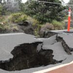 A cracked road after an earthquake, showcasing significant damage caused by seismic activity.