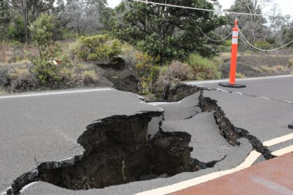 A cracked road after an earthquake, showcasing significant damage caused by seismic activity.