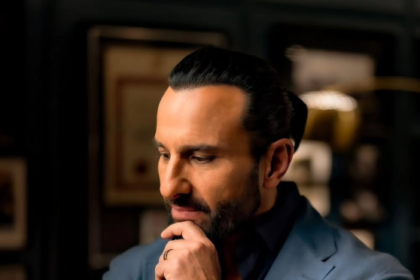 A professional portrait of Bollywood actor Saif Ali Khan, featuring him in a thoughtful pose, wearing a formal blue suit. The image is sourced from the official Instagram handle of Saif Ali Khan.