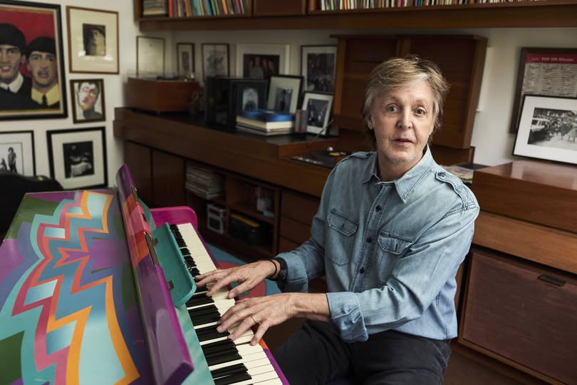 Paul McCartney playing the piano at home, showcasing his musical talent and timeless passion for music.