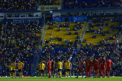 Packed football stadium with fans watching a Liga MX match between Club América and Necaxa at Estadio Ciudad de los Deportes.