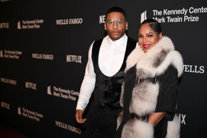 Singer Ashanti wearing a black gown at a red carpet event.