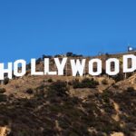 The iconic Hollywood sign in Los Angeles, symbolizing the entertainment industry's ongoing power struggles and the impact on major film productions in 2025.