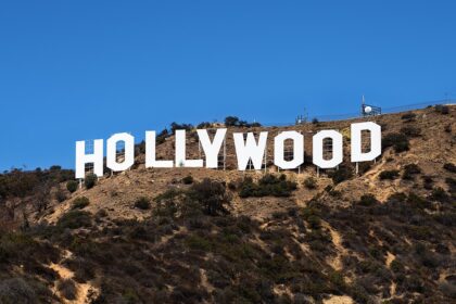 The iconic Hollywood sign in Los Angeles, symbolizing the entertainment industry's ongoing power struggles and the impact on major film productions in 2025.