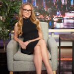 Kat Timpf wearing glasses and speaking at a public event