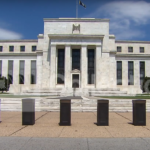 Federal Reserve building with a clear blue sky in the background.