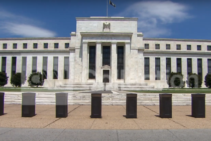 Federal Reserve building with a clear blue sky in the background.