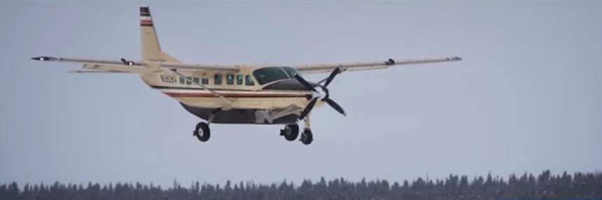 Small aircraft taking off from a remote Alaskan airstrip, symbolizing aviation in rugged terrain.