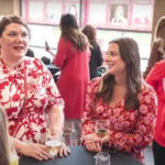 Women dressed in red celebrating National Wear Red Day 2025 to raise awareness for heart disease prevention.