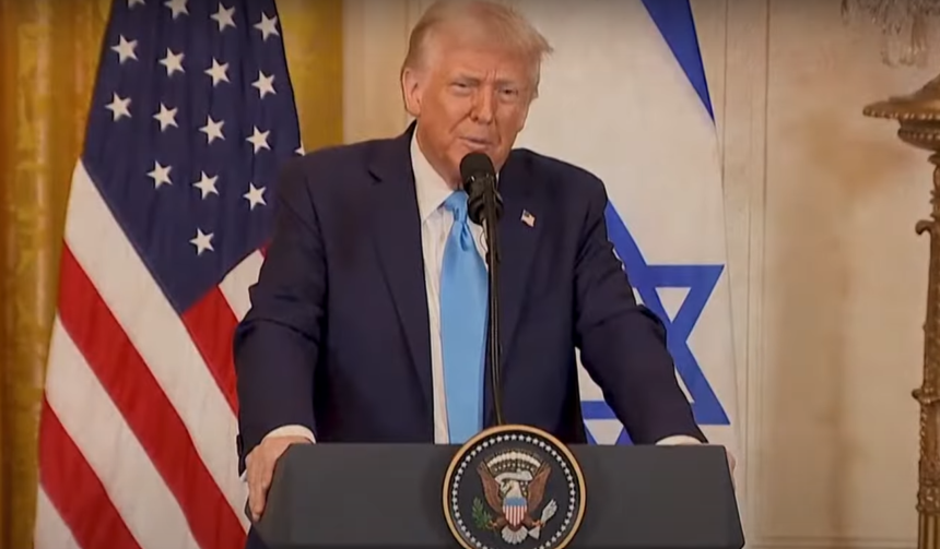 Donald Trump speaking at a podium with the U.S. and Israeli flags in the background.