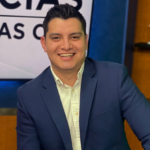 Adan Manzano, a Telemundo sports journalist, smiling in a studio setting.