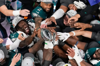 Philadelphia Eagles players celebrate their Super Bowl 59 victory, lifting the Vince Lombardi Trophy after defeating the Kansas City Chiefs.