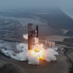 SpaceX rocket launch captured mid-flight, leaving a bright trail of smoke and fire as it ascends from the launch pad into the sky.