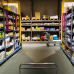 A well-stocked grocery store aisle with shelves filled with various products, symbolizing price changes and inflation trends.