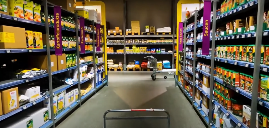 A well-stocked grocery store aisle with shelves filled with various products, symbolizing price changes and inflation trends.