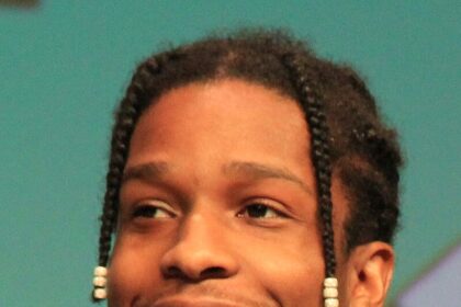 A$AP Rocky at a public event, smiling while addressing the media.