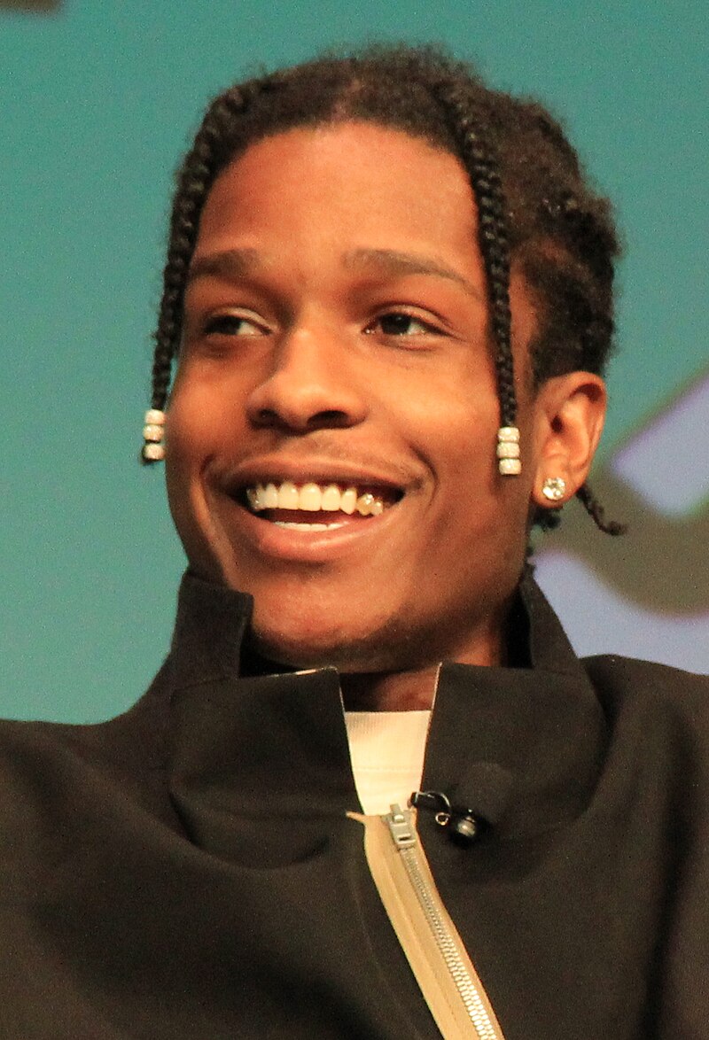 A$AP Rocky at a public event, smiling while addressing the media.