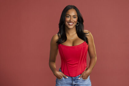 Beverly Ortega, The Bachelor Season 29 contestant, posing in a red top and jeans, smiling confidently.