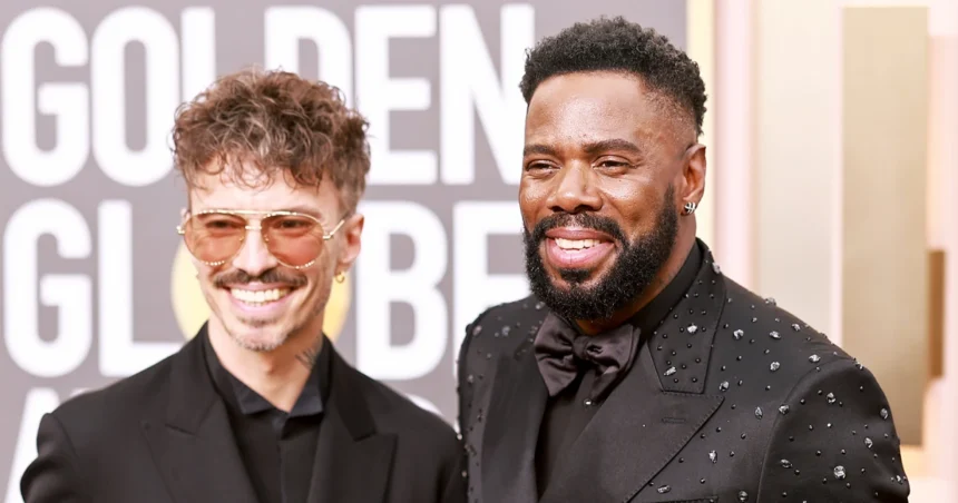 Colman Domingo smiling and posing in a stylish suit at an awards event