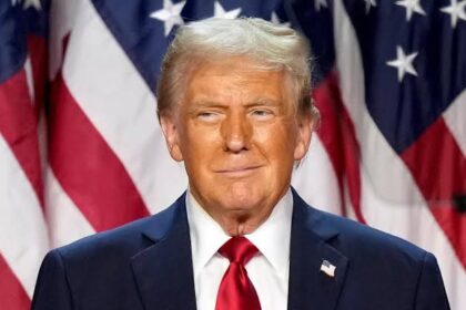 Former U.S. President Donald Trump in front of the American flag