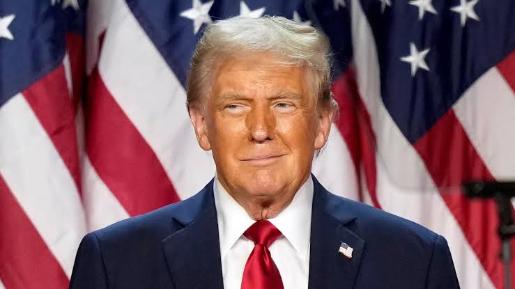 Former U.S. President Donald Trump in front of the American flag