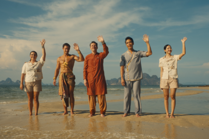 Cast of The White Lotus Season 3 standing on a beach in Thailand, set against a dramatic sunset, representing the show’s new exotic and mysterious setting.